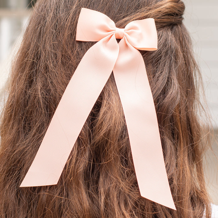 little girl wearing a Moonstone Birdie Hair Bow