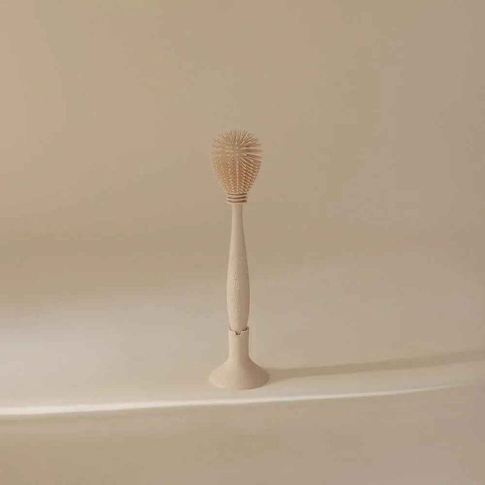 Mushie® Silikonska krtačka za čiščenje Shifting Sand Mushie