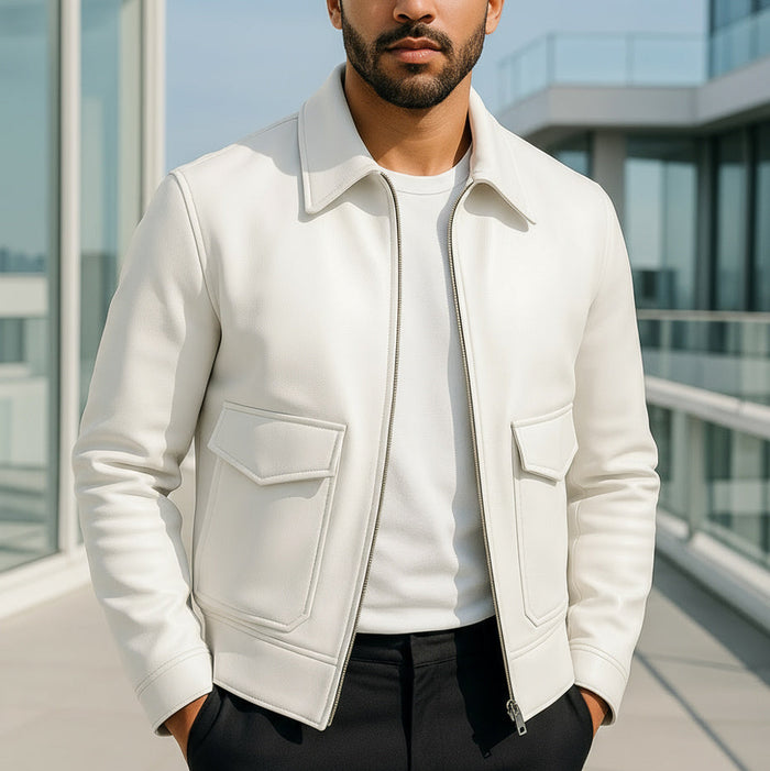 Man wearing a white jacket with a modern building in the background