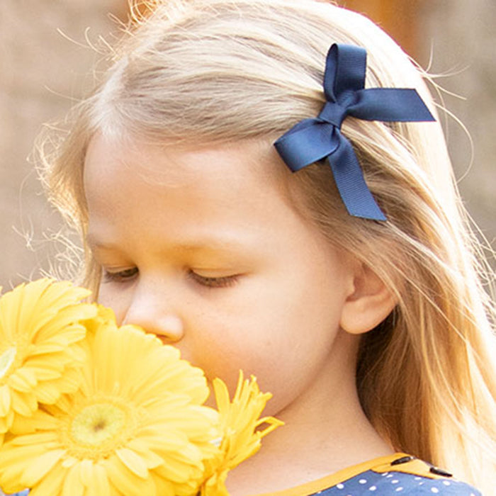 little girl wearing a Navy Bitty Bow