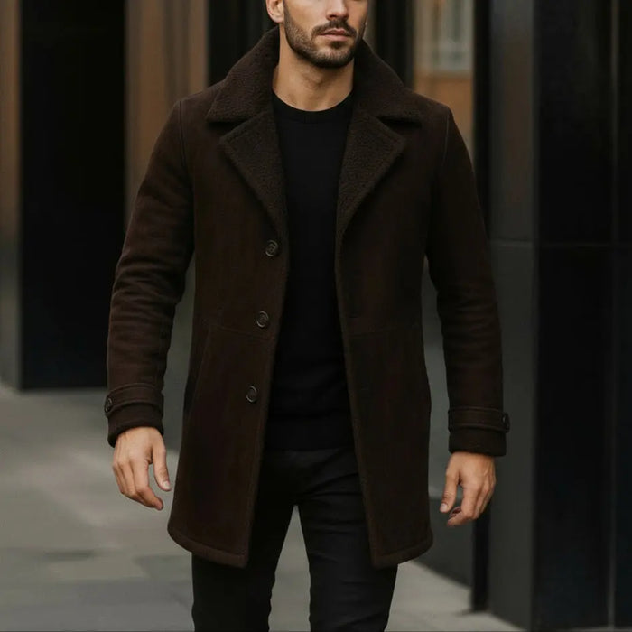 Man wearing a brown coat walking on a street.