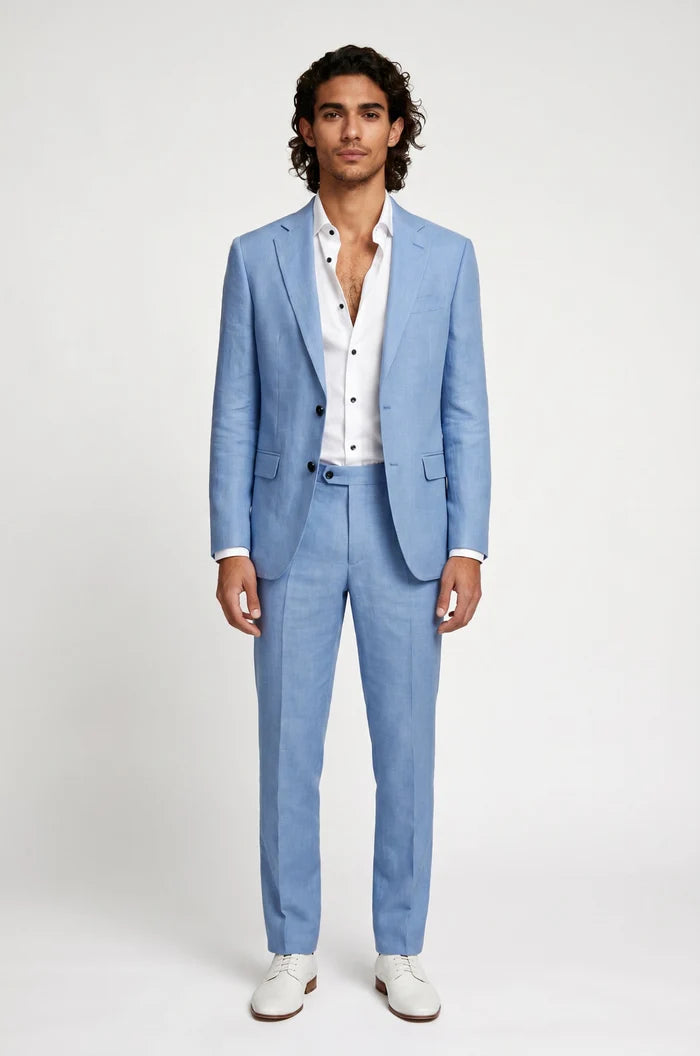 Man wearing a light blue linen suit with a white shirt on a plain background