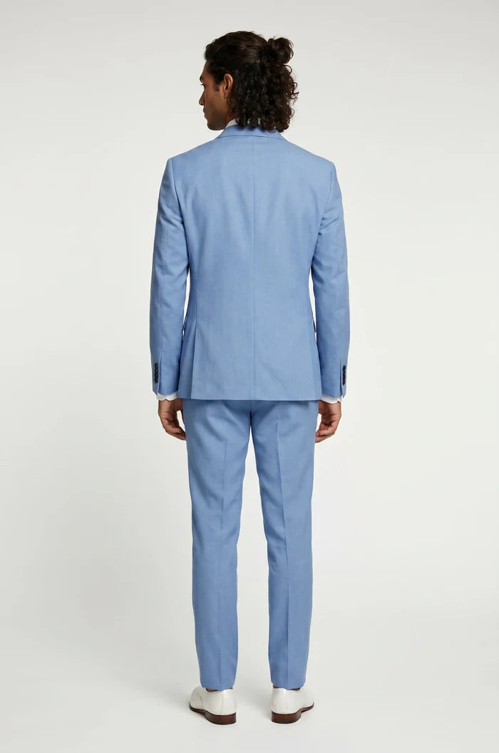 Man wearing a light blue linen suit on a white background