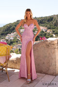 A model wears a shimmering light pink strapless gown with a high slit.