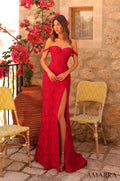 A woman in a red lace gown with a high slit stands on a stone patio with yellow chairs and pink bougainvillea.