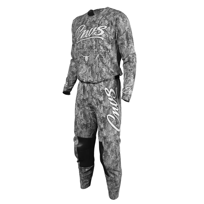 A long-sleeve motocross jersey and matching pants set in a gray and black camouflage pattern, featuring white 'Cnvs' script logos on the chest and thigh, with black knee panels, shown on a plain white background.